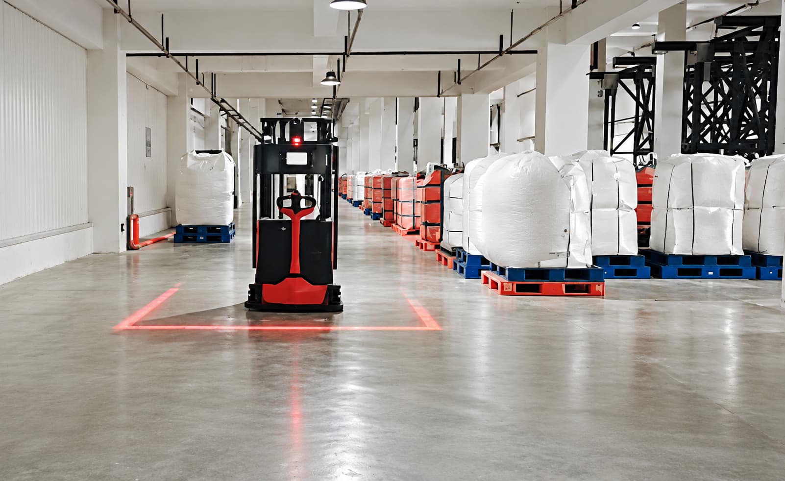 Forklift AMR moving palletized bags in a plant aisle