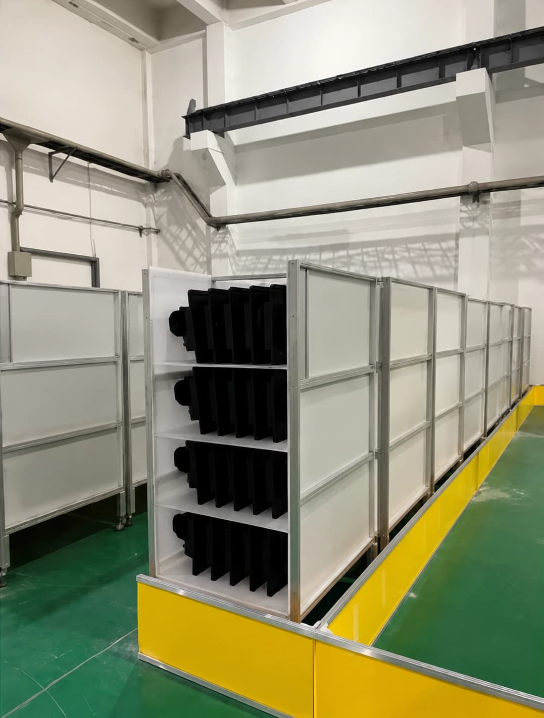 Wheeled component racks staged in marked floor positions